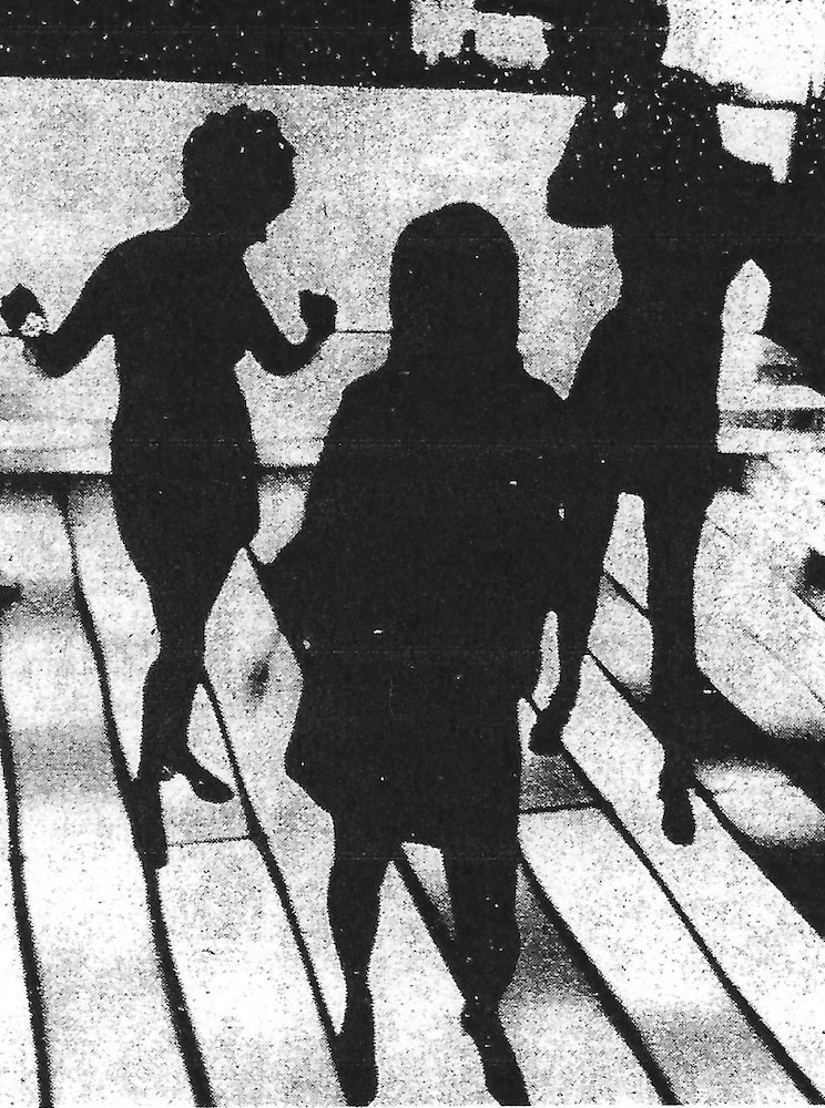 Dancers silhouetted on the Mad Hatter's flashing stage